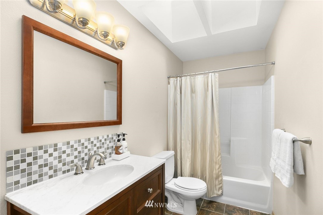 23809 Southeast 243rd Street Maple Valley, WA 98038 - Photo 26 of 40 a bathroom with a sink a toilet and a mirror