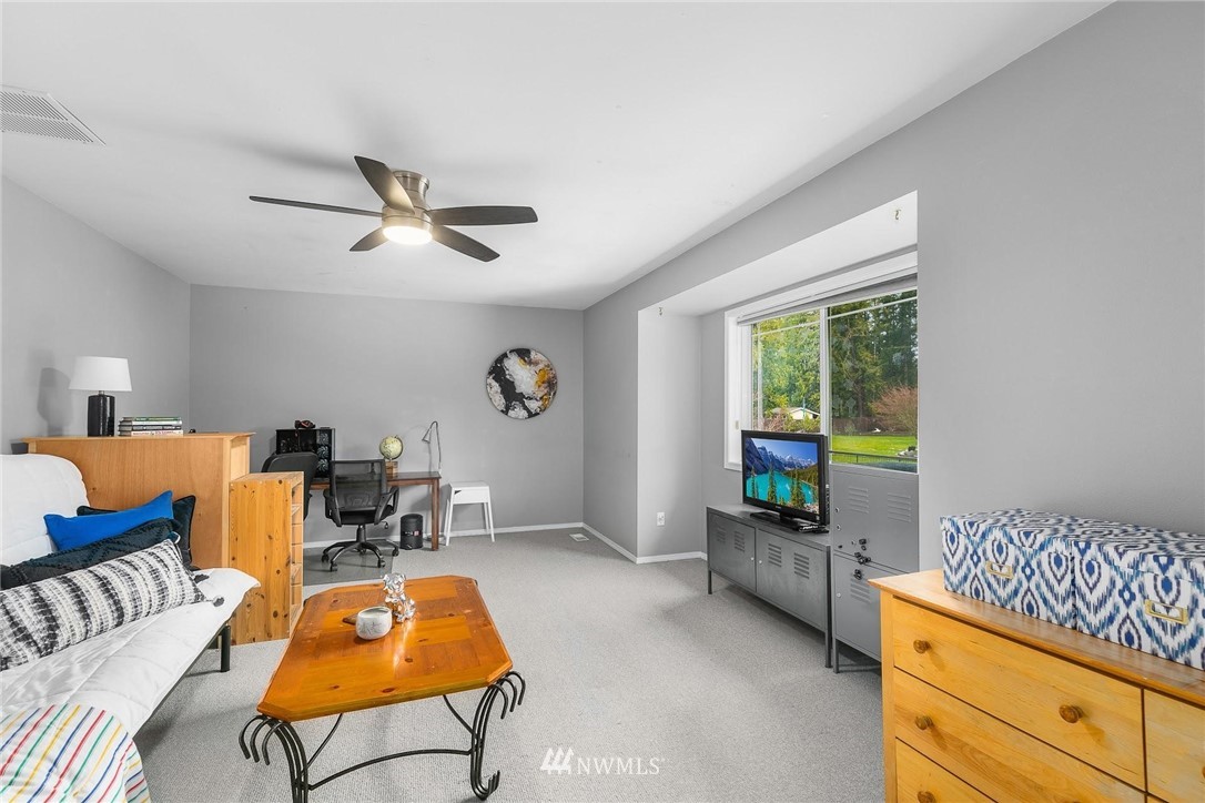 23809 Southeast 243rd Street Maple Valley, WA 98038 - Photo 27 of 40 a living room with furniture a air conditioner vent and a window