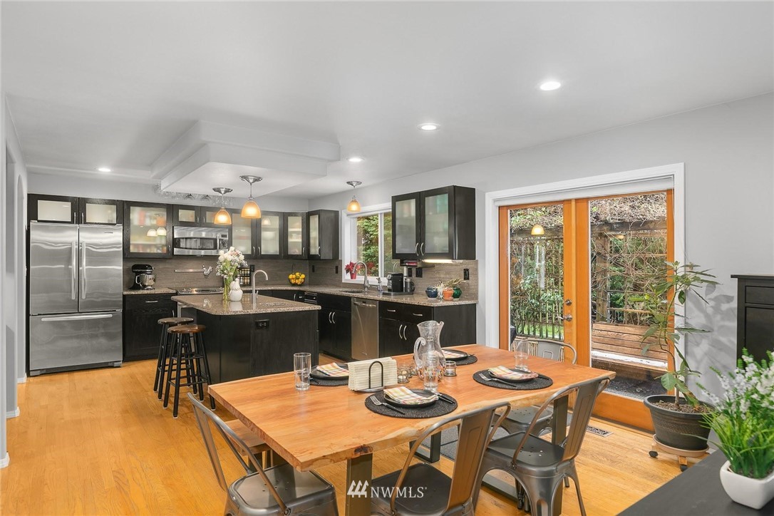 23809 Southeast 243rd Street Maple Valley, WA 98038 - Photo 9 of 40 a kitchen with a table and chairs in it