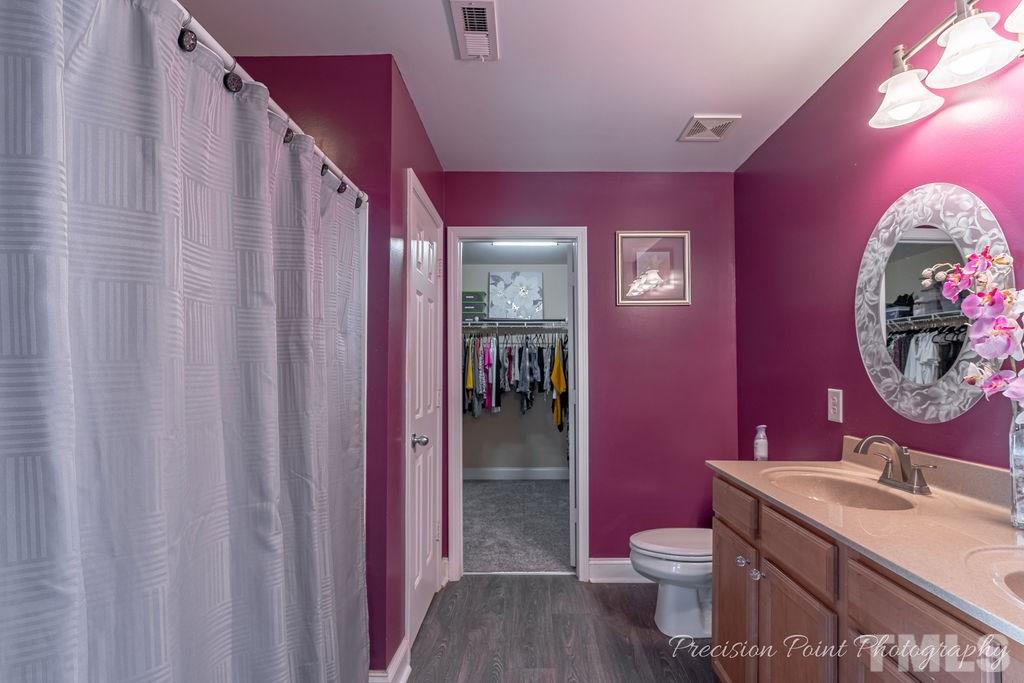 316 Steel Hopper Way Garner, NC 27529 - Photo 12 of 19 a bathroom with a sink a vanity and a mirror