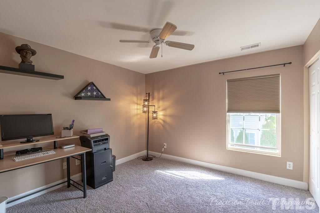 316 Steel Hopper Way Garner, NC 27529 - Photo 13 of 19 a view of a workspace with furniture and a window