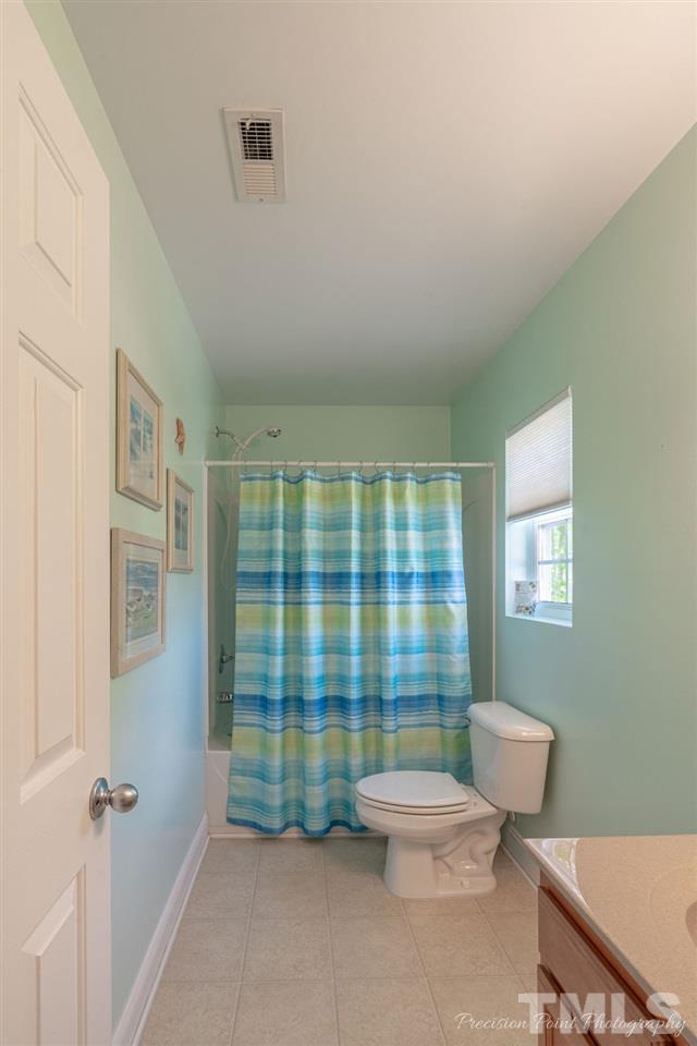 316 Steel Hopper Way Garner, NC 27529 - Photo 15 of 19 a bathroom with a toilet a sink and shower
