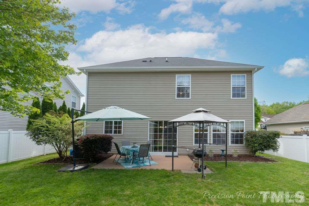 316 Steel Hopper Way Garner, NC 27529 - Photo 19 of 19 a backyard of a house with table and chairs