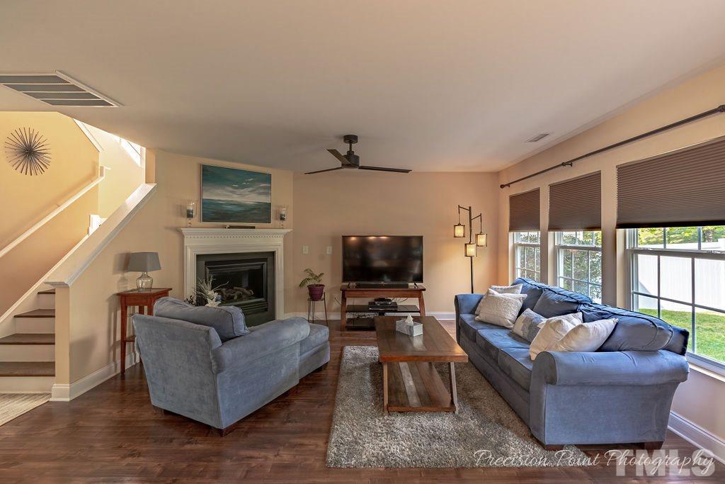316 Steel Hopper Way Garner, NC 27529 - Photo 3 of 19 a living room with furniture a fireplace and a flat screen tv