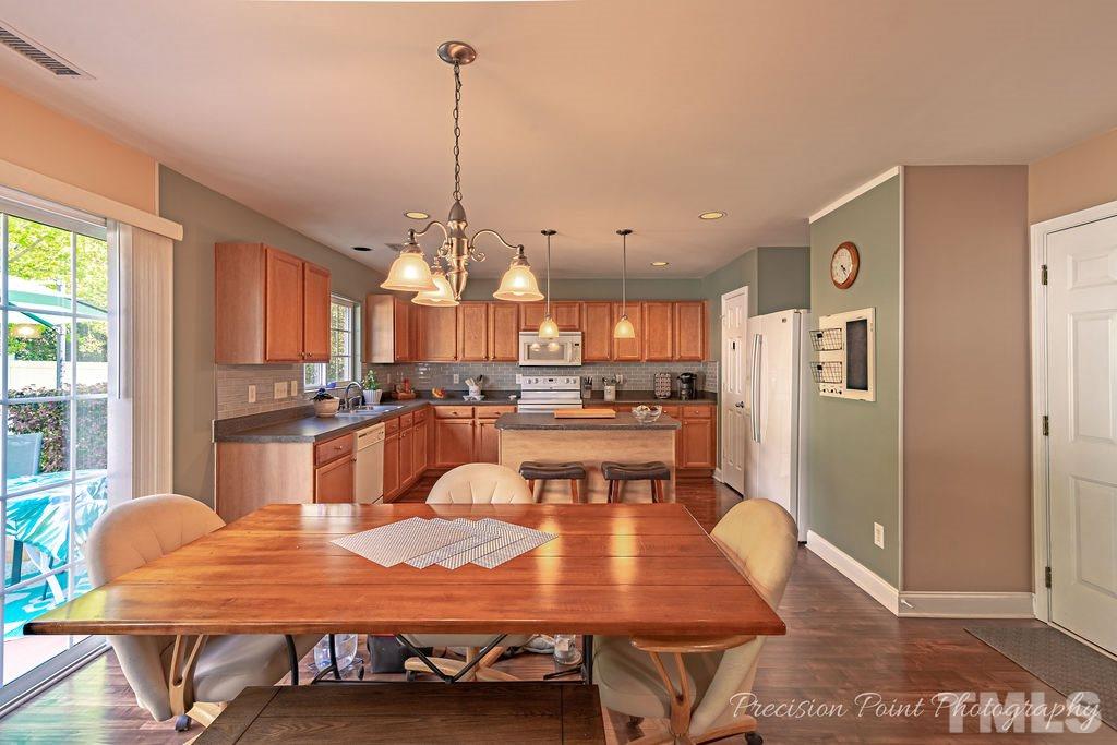 316 Steel Hopper Way Garner, NC 27529 - Photo 4 of 19 a large kitchen with a table and chairs