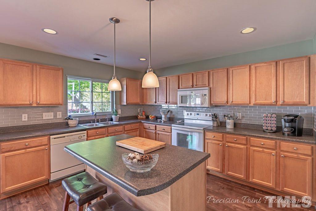 316 Steel Hopper Way Garner, NC 27529 - Photo 5 of 19 a kitchen with a sink stove and window