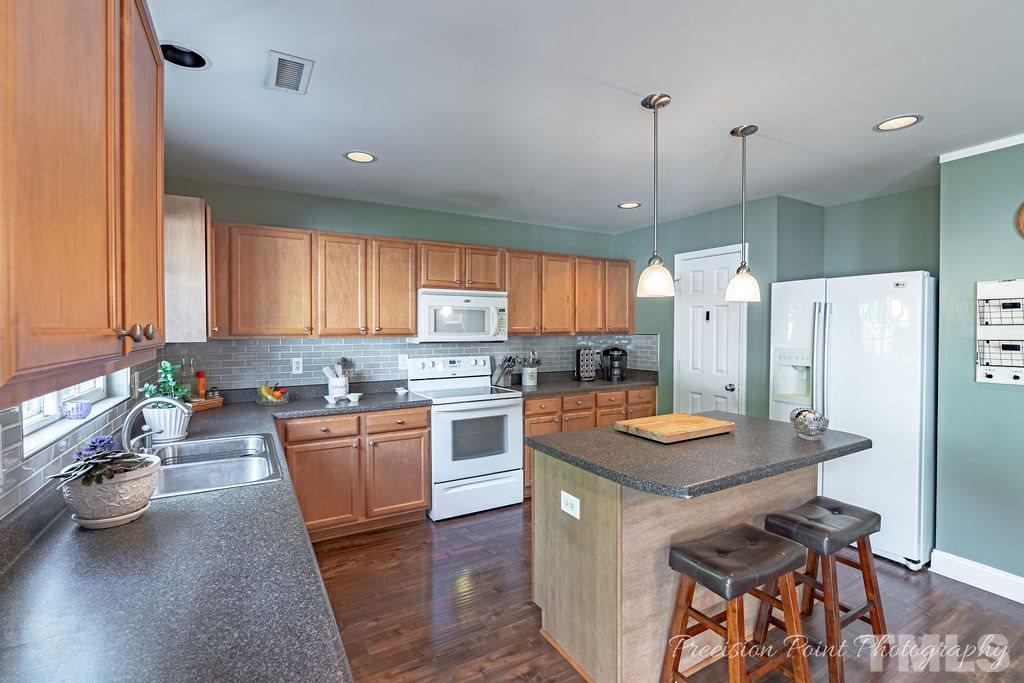 316 Steel Hopper Way Garner, NC 27529 - Photo 6 of 19 a kitchen with stainless steel appliances granite countertop a stove refrigerator and a sink