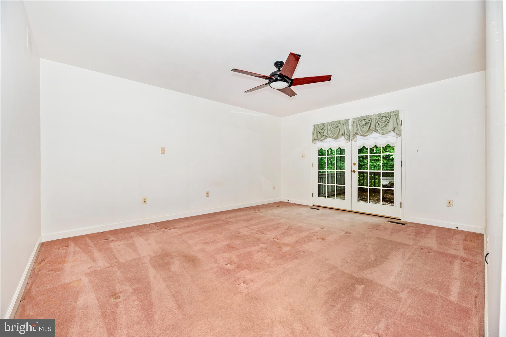 2221 Gold Mine Road Brookeville, MD 20833 - Photo 27 of 60 a view of a livingroom with a ceiling fan and window