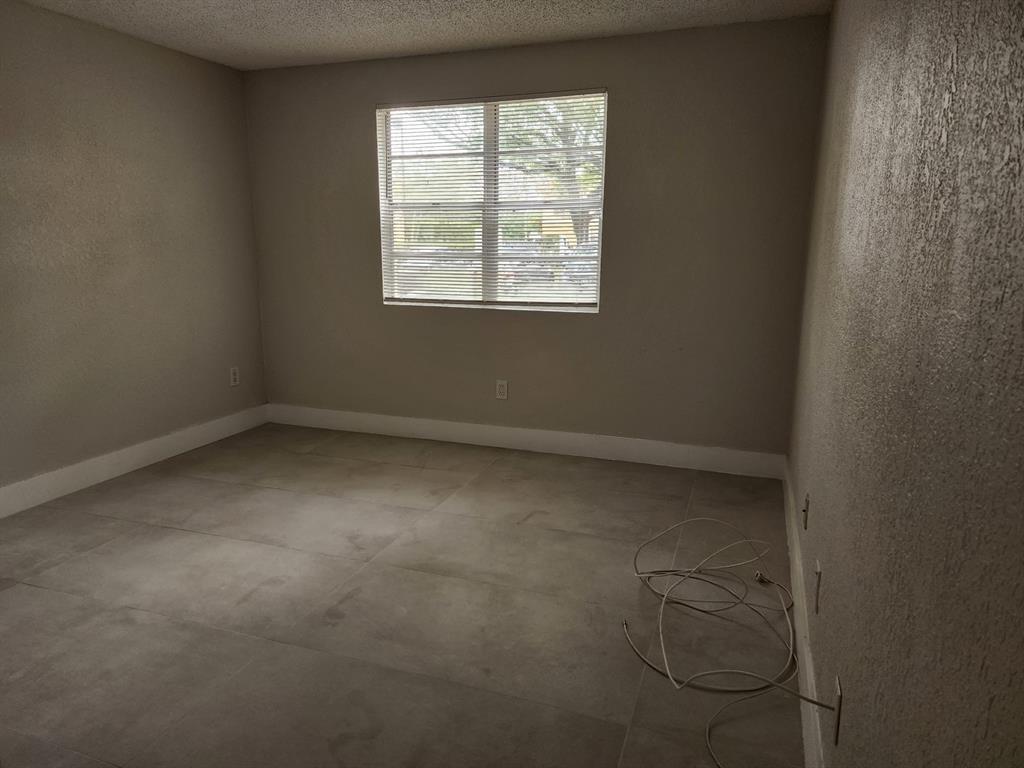 1229 Southwest 46th Avenue, Unit 405 Pompano Beach, FL 33069 - Photo 12 of 26 an empty room with windows