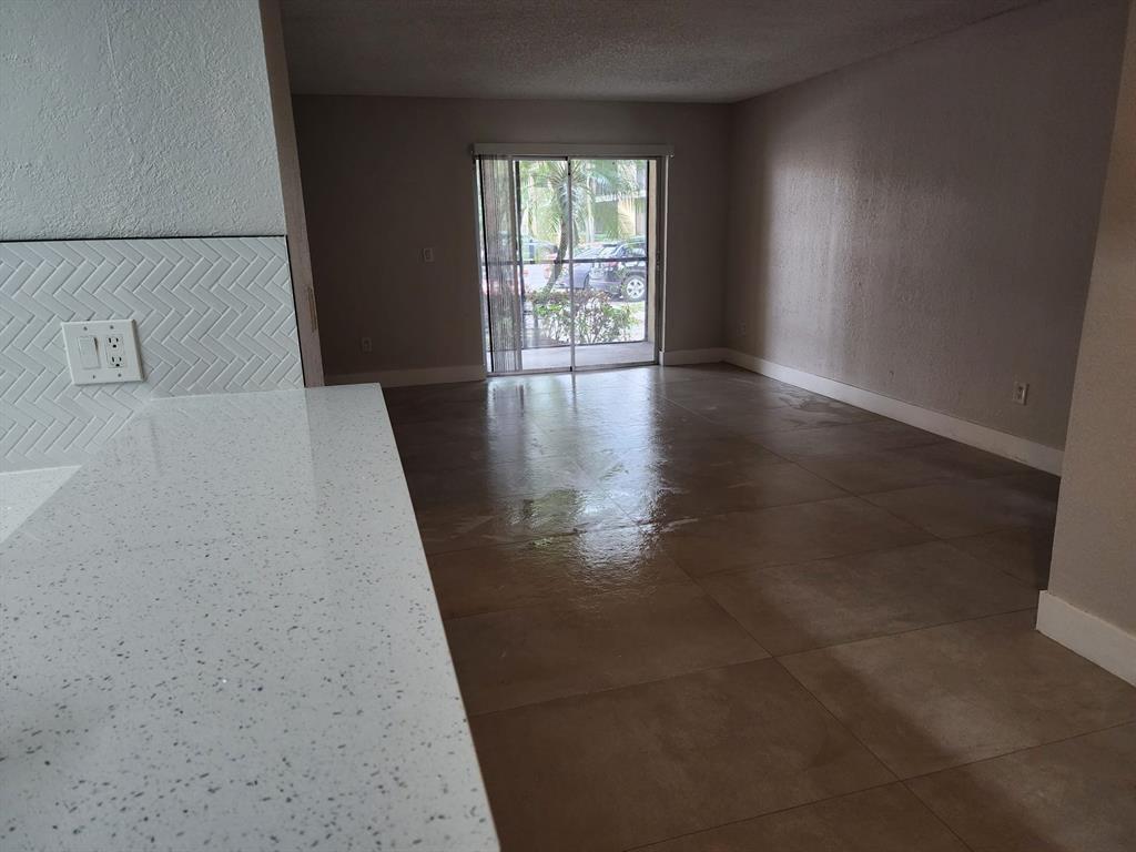 1229 Southwest 46th Avenue, Unit 405 Pompano Beach, FL 33069 - Photo 13 of 26 wooden floor in an empty room with a window