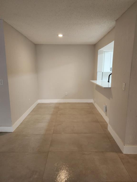 1229 Southwest 46th Avenue, Unit 405 Pompano Beach, FL 33069 - Photo 15 of 26 a view of an empty room with a window
