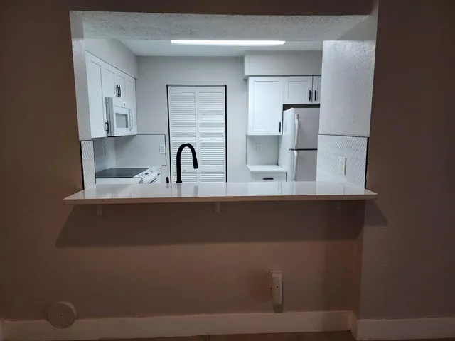 a kitchen with cabinets and stainless steel appliances