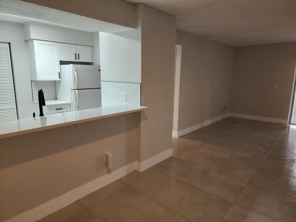 1229 Southwest 46th Avenue, Unit 405 Pompano Beach, FL 33069 - Photo 24 of 26 a kitchen with cabinets and stainless steel appliances