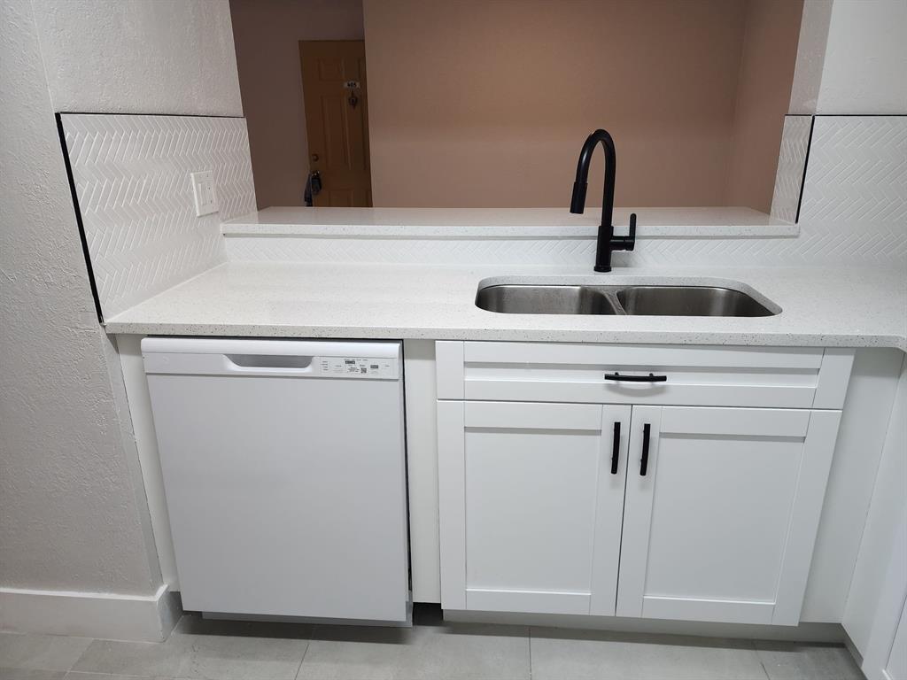 1229 Southwest 46th Avenue, Unit 405 Pompano Beach, FL 33069 - Photo 4 of 26 a close view of a sink a washer and dryer