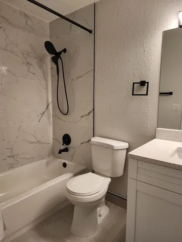 a bathroom with a toilet a sink and shower