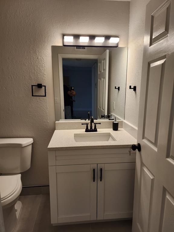 1229 Southwest 46th Avenue, Unit 405 Pompano Beach, FL 33069 - Photo 6 of 26 a bathroom with a toilet sink and mirror