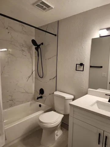 a bathroom with a toilet sink and shower