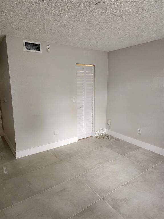 1229 Southwest 46th Avenue, Unit 405 Pompano Beach, FL 33069 - Photo 9 of 26 an empty room with an empty space