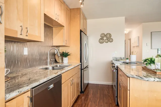 a kitchen with a sink stove and cabinets