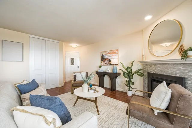 a living room with furniture and a fireplace