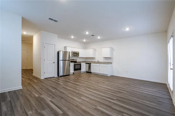 a view of kitchen with wooden floor