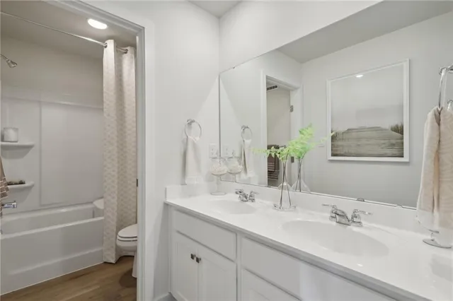 a bathroom with a tub a sink and mirror