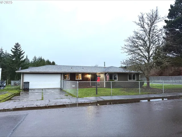 a front view of a house with a garden and plants