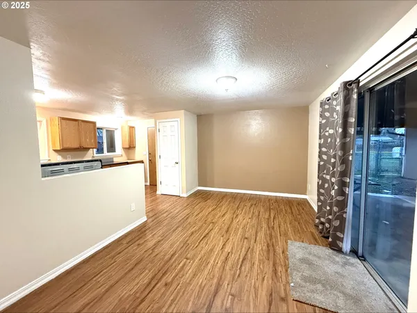 a large kitchen with stainless steel appliances granite countertop a stove and a wooden floors