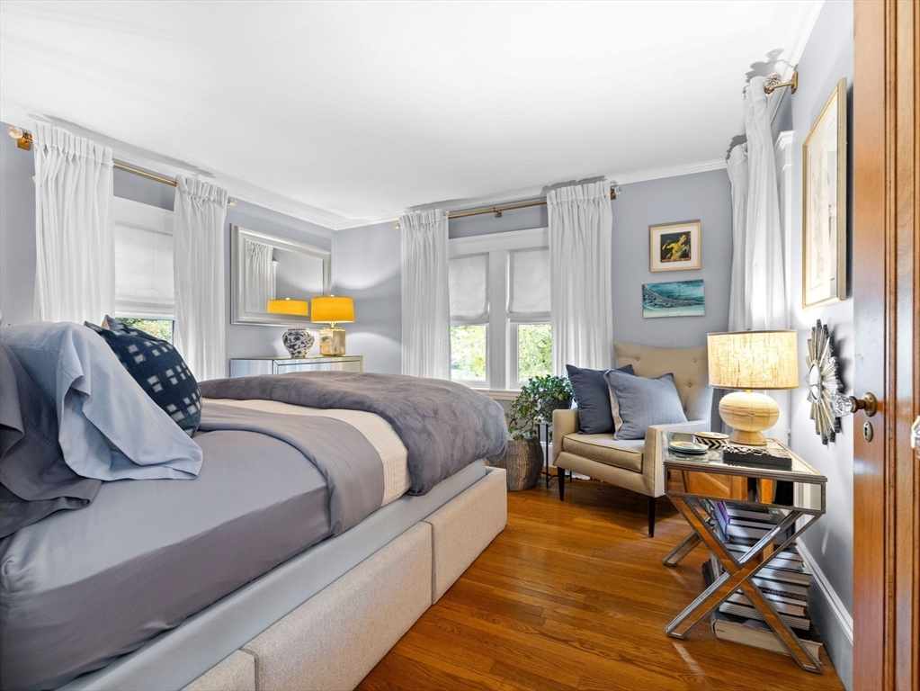 81 Arborway Boston, MA 02130 - Photo 14 of 29 a bedroom with furniture and a window