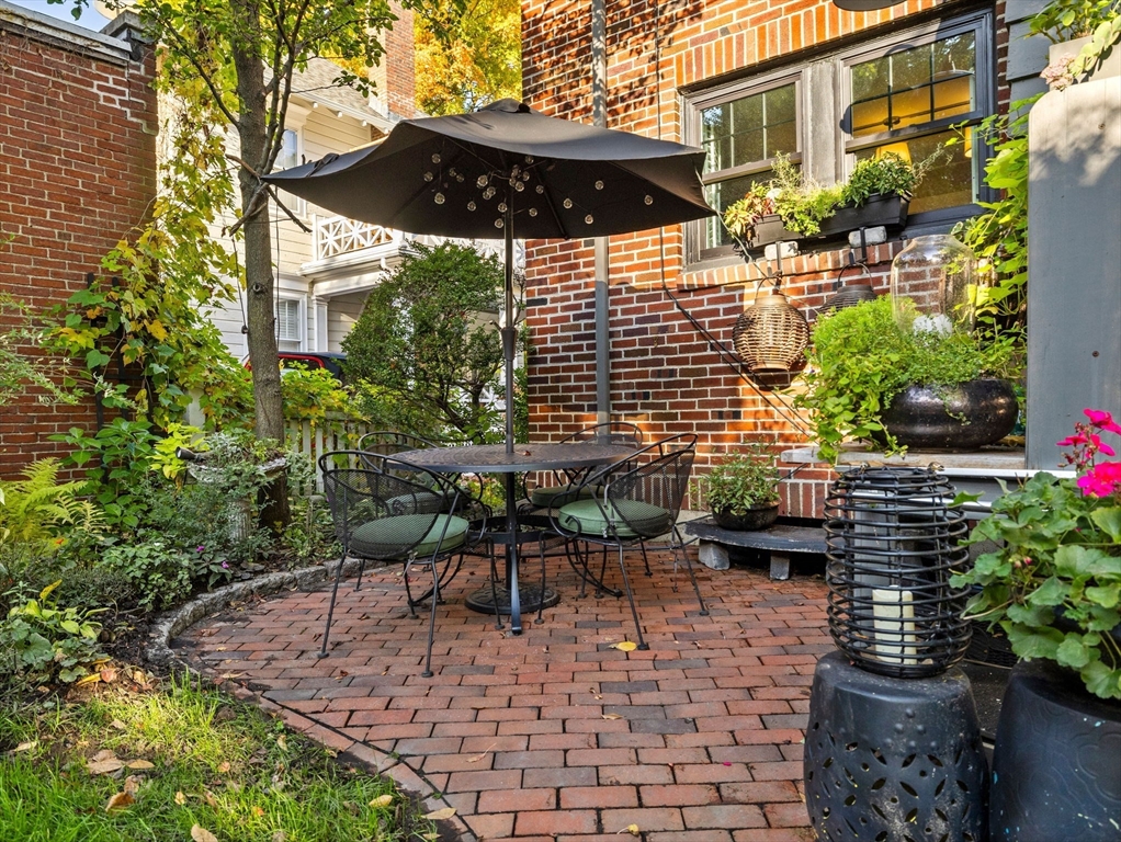 81 Arborway Boston, MA 02130 - Photo 23 of 29 a view of a chairs and table in backyard