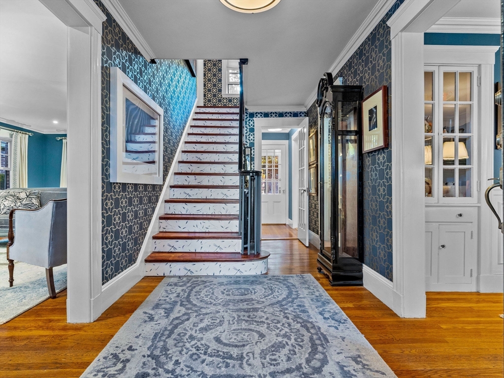 81 Arborway Boston, MA 02130 - Photo 3 of 29 a view of entryway with wooden floor and stairs