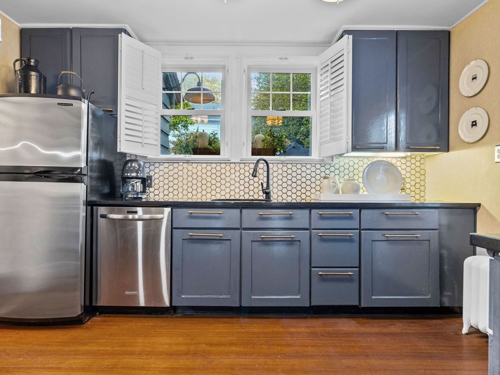 81 Arborway Boston, MA 02130 - Photo 10 of 29 a kitchen with kitchen island granite countertop a sink and a window