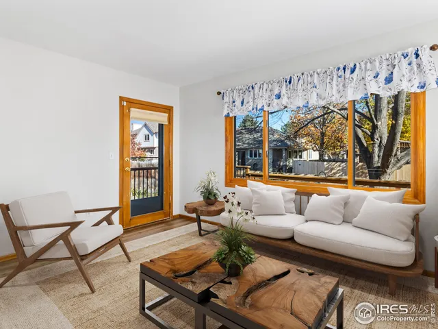 a view of a balcony with wooden floor and outdoor seating