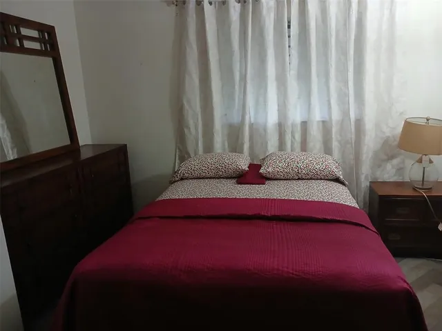 a bedroom with a bed and a mirror