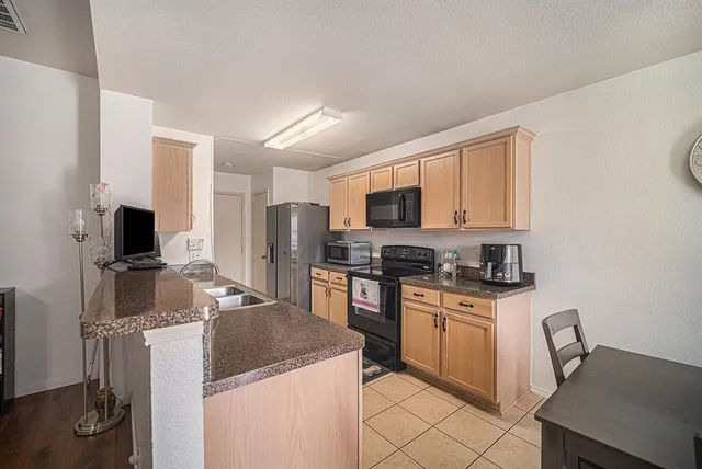 a kitchen with a stove sink and microwave