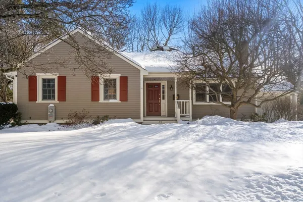 a view of a house with snow on the road