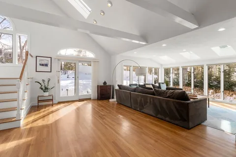 a living room with furniture and large windows
