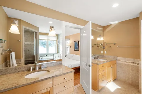a bathroom with a granite countertop sink mirror and a