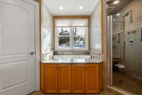 a bathroom with a granite countertop sink a mirror and a shower