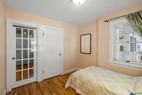 a bedroom with a bed and a window
