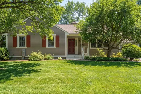 a front view of house with yard and green space