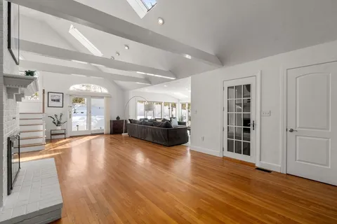 a living room with fireplace furniture and a wooden floor