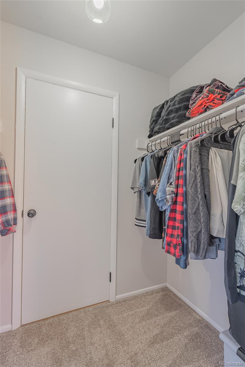 6727 Dale Road Colorado Springs, CO 80915 - Photo 11 of 18 a view of walk in closet with clothes and shoes