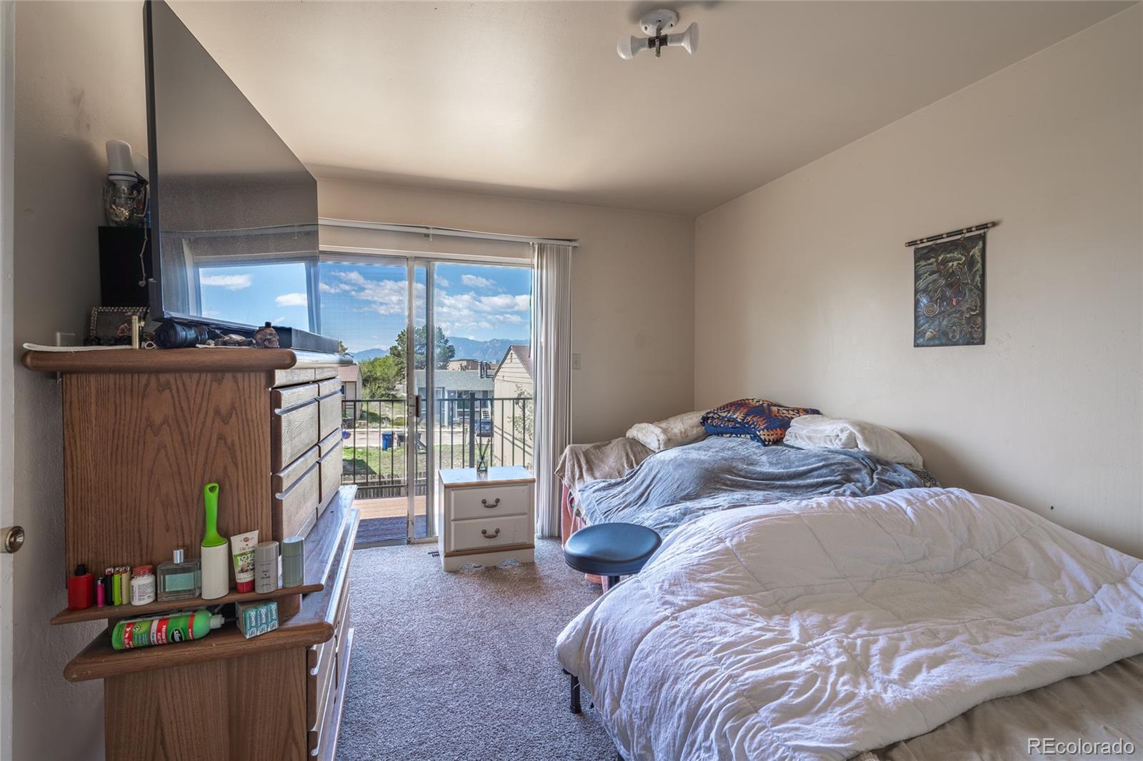 6727 Dale Road Colorado Springs, CO 80915 - Photo 12 of 18 a bed sitting in a bedroom next to a window