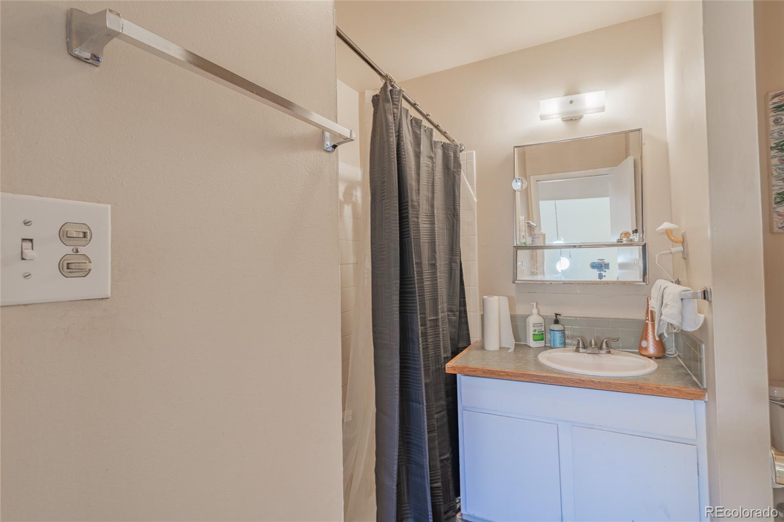 6727 Dale Road Colorado Springs, CO 80915 - Photo 15 of 18 a bathroom with a sink and a mirror