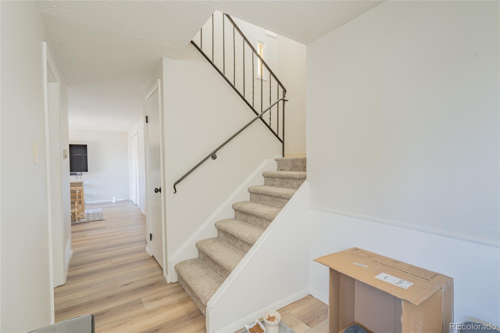 6727 Dale Road Colorado Springs, CO 80915 - Photo 8 of 18 a view of entryway and hall with wooden floor