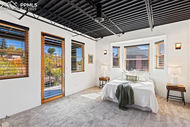 a spacious bedroom with a bed and a couch