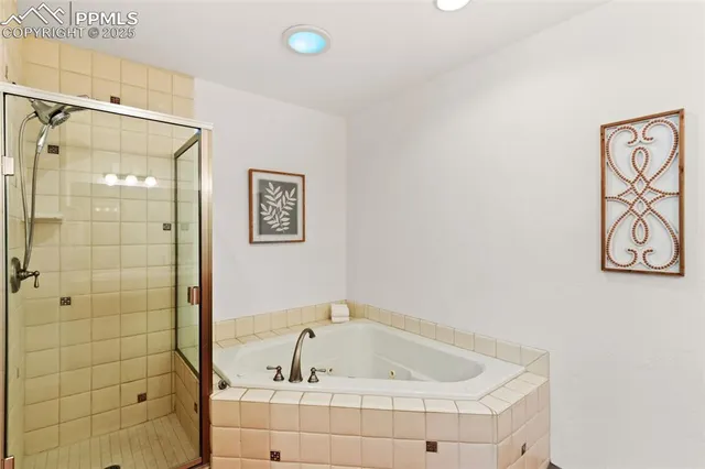 a bathroom with a tub and shower