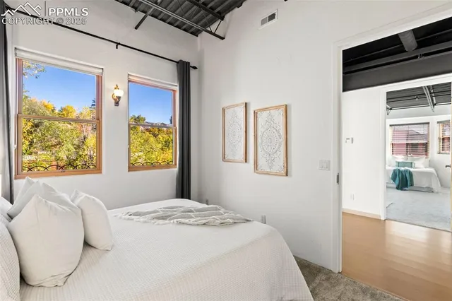 a bedroom with a bed and a large window