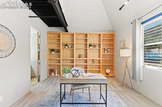 a view of a room that has a table and a chair